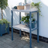 Garden Potting table with plants on in front of a white wall