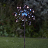 A garden wind spinner with rotating arms and a color-changing globe, featuring a brushed bronze effect finish.