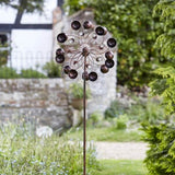 Windspinner round bobbles in a garden with house in background