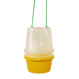 A yellow and clear wasp trap with a yellow base and a clear cylindrical cover suspended by green strings.