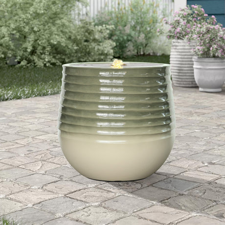 Green ceramic planter on a stone patio 