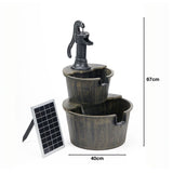 Water feature made of 2 wood effect tubs, larger on bottom, smaller on top with handled pump