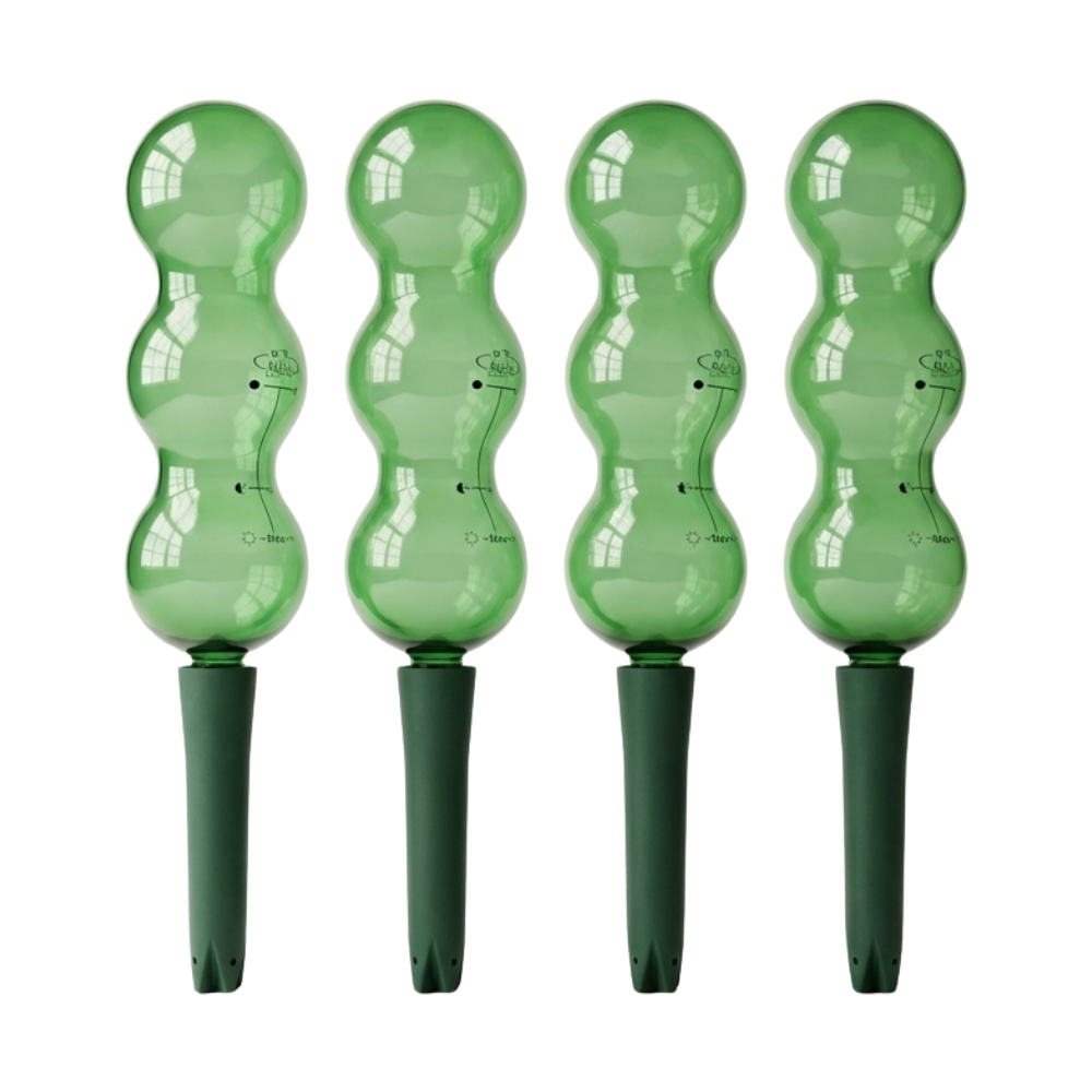 Four green plastic plant markers with wavy design on a white background