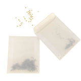 Seed envelopes with loose seeds on a white background