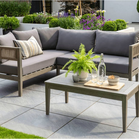Outdoor garden sofa wooden with wooden coffee table in a garden on a patio